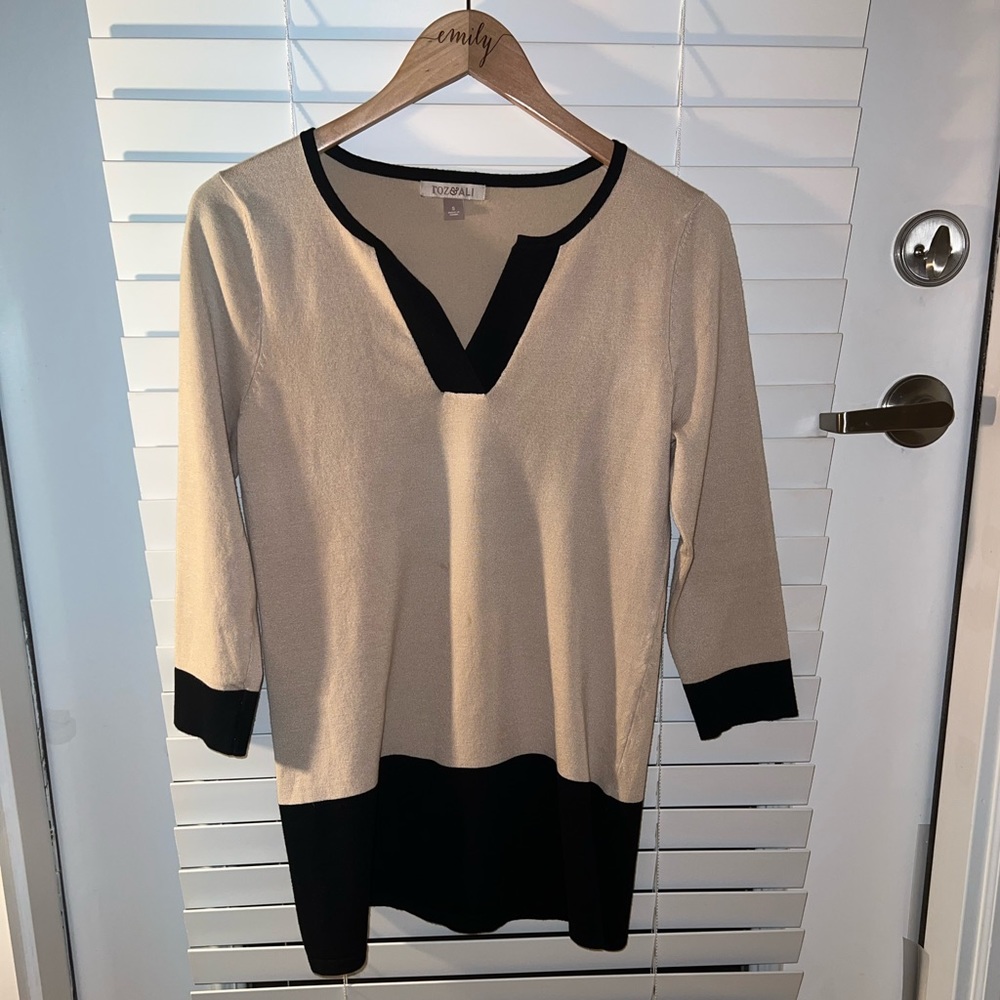 Tan and black tunic style top with 3/4 length sleeves.